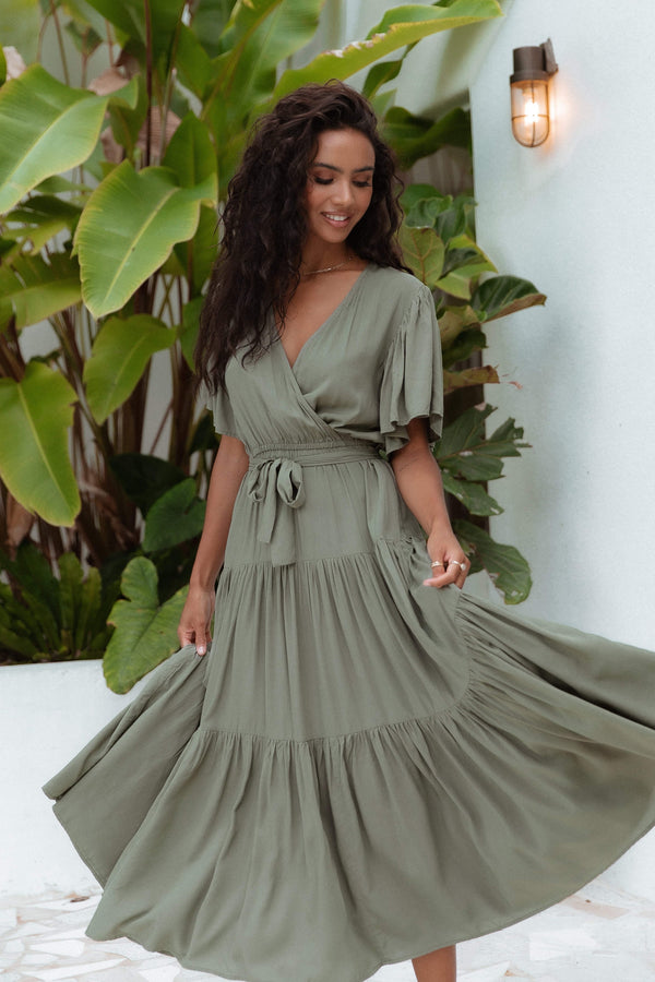 DRESSES Barker Dress -  Midi length, flutter sleeve, wrap dress in a classic neutral olive. V-Neck line with a bow to complete the wrap waist look. Perfect for wedding guests, baby showers and sprinkles, day dates, hens parties and more! A luxe yet affordable staple for every woman's closet. 