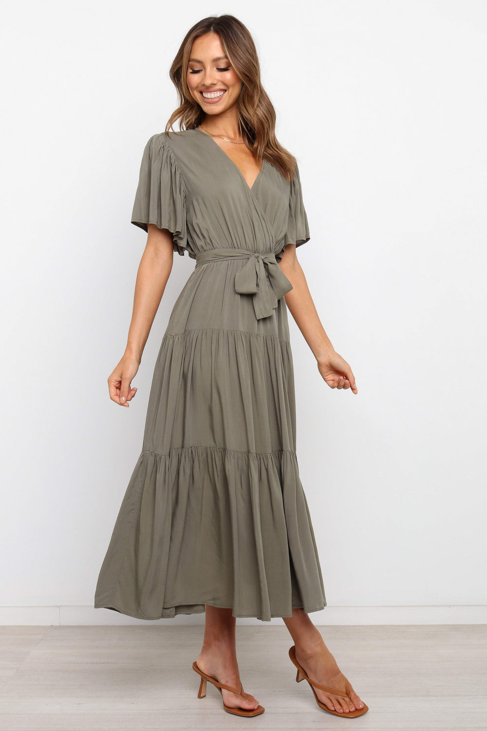 DRESSES Barker Dress -  Midi length, flutter sleeve, wrap dress in a classic neutral olive. V-Neck line with a bow to complete the wrap waist look. Perfect for wedding guests, baby showers and sprinkles, day dates, hens parties and more! A luxe yet affordable staple for every woman's closet. 