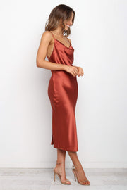 DRESSES Persia Dress - Rust 12  Stunning cowl neck, midi dress with adjustable straps in a sexy satin fabrication. Offering a flattering feminine silhouette that can be dressed up or dressed down. Perfect for weddings, date nights, Spring parties, brunch, day events, and more. 