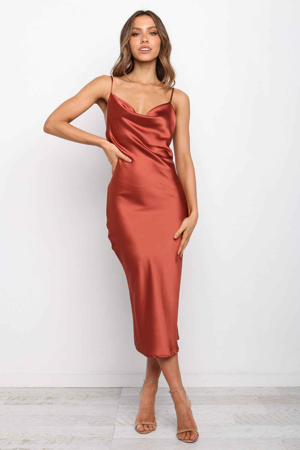 DRESSES Persia Dress - Rust  Stunning cowl neck, midi dress with adjustable straps in a sexy satin fabrication. Offering a flattering feminine silhouette that can be dressed up or dressed down. Perfect for weddings, date nights, Spring parties, brunch, day events, and more. 