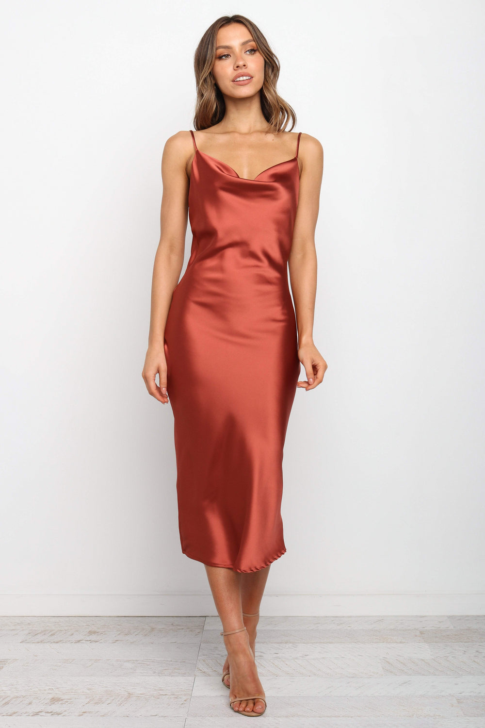 DRESSES Persia Dress - Rust  Stunning cowl neck, midi dress with adjustable straps in a sexy satin fabrication. Offering a flattering feminine silhouette that can be dressed up or dressed down. Perfect for weddings, date nights, Spring parties, brunch, day events, and more.  Perfect that Y2K look. 