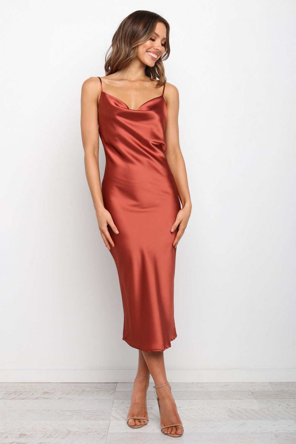 DRESSES Persia Dress - Rust 6 DRESSES Persia Dress - Rust 8 Stunning cowl neck, midi dress with adjustable straps in a sexy satin fabrication. Offering a flattering feminine silhouette that can be dressed up or dressed down. Perfect for weddings, date nights, Spring parties, brunch, day events, and more. 